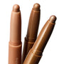 Shimmering Golds ColourPop Shadow Stix trio showing uncapped metallic gold and bronze cream eyeshadow tips catching light, angled side by side in a macro close-up on white, highlighting twist-up crayon packaging for quick swipe-on eye looks.