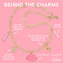 Brooklyn Charm x ColourPop Necklace showcases a gold link chain with enamel charms - pink lips reading ColourPop, So Juicy lip oil tube, bunny, strawberry, and pink beaded vial - laid flat on a pink background for a playful, beauty-inspired vibe.