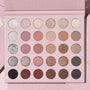 Major Eye Candy shadow palette & brush set by ColourPop, opened to 30 pans of mattes and glitter metallics in nudes, mauves, pinks, taupes, coppers, silver, charcoal, and black, displayed in a blush‑pink case on a pale pink background.