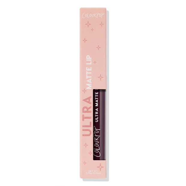 ColourPop Ultra Matte Lip in Currant Mood - deep berry liquid lipstick displayed upright in a blush-pink starry box with window revealing the tube, 3.7g/0.13oz, product photo on a white background.