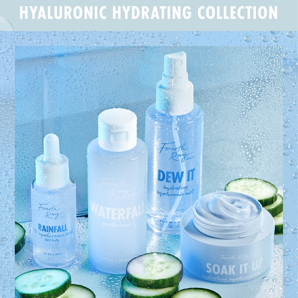 Open jar of Fourth Ray Beauty Soak It Up Hydrating Mask shows a whipped, dewy cream, staged beside Waterfall gentle tonic, Dew It mist, and Rainfall serum with cucumber slices on misted blue glass, highlighting this ColourPop Face Mask for deep hydration.