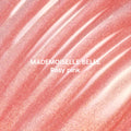 Mademoiselle Belle Ultra Glossy Lip swatch showing shimmery rosy pink Disney Princess–inspired lip gloss spread in smooth, diagonal streaks with fine gold sparkle on a metallic background, highlighting its ultra-glossy finish.