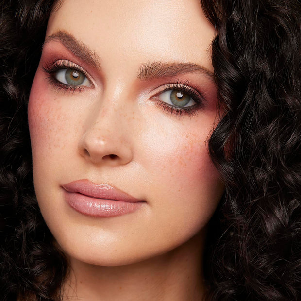 Rosy mauve eyeshadow and soft pink blush highlight a model’s eyes and cheeks, showcasing Cloud Baby ColourPop Shadow Palette Set shades with shimmer at the inner corners, wispy lashes, and nude gloss lips in a close-up studio beauty shot.