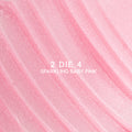 Heart to Get 2 Die 4 ultra glossy lip swatch showing sparkling baby pink shimmer in diagonal, textured streaks against a smooth pastel background, highlighting the high-shine, glittery finish for US makeup lovers.