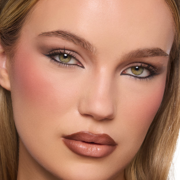 Warm brown smoky eye showcases Deja Brew ColourPop Shadow Palette on a close-up face, with matte and shimmer neutrals blended on lids, soft eyeliner and mascara, nude brown lips, and peach blush in a studio beauty shot.