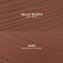 Swatches showcase Hello Biceps lippie pencil and Jake ColourPop Power Pout Lipstick from the Bella! Where the Hell Have You Been, Loca? kit, with textured mocha and smooth cinnamon-brown strokes on a matte surface highlighting creamy payoff.