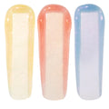 Evolution Ultra Glossy Lip swatches display three iridescent ColourPop Ultra Glossy Lip strokes - golden pearl, peachy pink, and icy blue‑lilac - shimmering with micro‑glitter to show a sheer high‑shine finish on a white background.