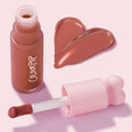 Culver City ColourPop Liquid Blush swatched in a warm terracotta rose, with a doe-foot applicator and pink heart-shaped cap beside a frosted bottle, glossy pigment forming a heart on a pastel pink background.