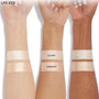 ColourPop Lite Stix highlighter in Sunlight swatched on three forearms - light, medium, and deep skin - showing a warm champagne glow; Glazey swatch sits above for comparison, labels visible in a clean studio product shot.