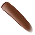 Manhattan Beach Bronzer Stix swatch sweeps diagonally in a smooth, creamy streak, showing a rich deep bronze-brown satin finish on a white background; ColourPop Bronzer Stix shade for sun-kissed warmth and contour.