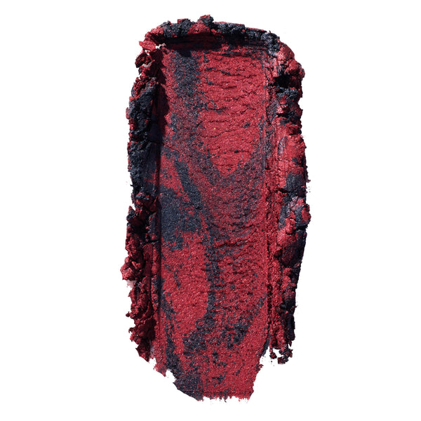The Volturi ColourPop Super Shock Shadow swatch, smeared in a thick swipe to reveal a metallic crimson red base marbled with inky black shimmer, showing creamy, high-pigment payoff on a clean white background.