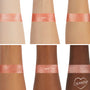 Sequin Super Shock Shadow swatch gleams across six forearms, showing smooth, opaque payoff on light to deep skin tones; a metallic rose‑gold copper shimmer band on each arm, with the ColourPop heart logo in the bottom right.