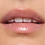 Glossed lips wearing Gumdrop Buttons Candy Lip Oil, showing a sheer high-shine pink tint from ColourPop Candy Lip Oil, captured in a tight on-model close-up under studio lighting.