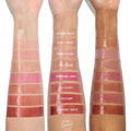 Lychee Jelly swatched on three forearms from light to deep skin tones, a sheer glossy pink at the wrist among labeled shades, showcasing the shine and plumping payoff of the ColourPop So Juicy Plumping Glossy Lip Oil.