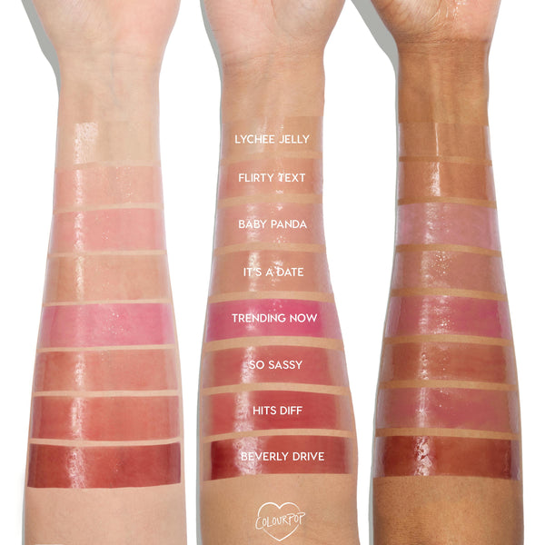 ColourPop So Juicy Lip Oil Set Juicy Moment swatches display glossy bands - Lychee Jelly, Flirty Text, Baby Panda, It’s a Date, Trending Now, So Sassy, Hits Diff, Beverly Drive - applied on three skin tones, studio lighting highlighting the high-shine finish.