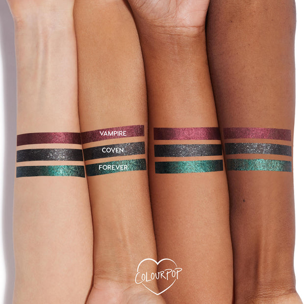 ColourPop Graphix Ink Liner in Vampire swatched as a metallic burgundy stripe on three arms in light, medium, and deep tones, shown beside Coven (glittery black) and Forever (teal-green) for shade comparison; long-wearing, high-shine.