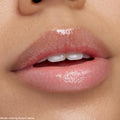 Glossy lips wearing Squad Dreams ColourPop Ultra Glossy Lip, a sheer high-shine gloss with fine iridescent sparkle, reflecting light in a tight macro close-up of a mouth for a juicy, plumped finish.
