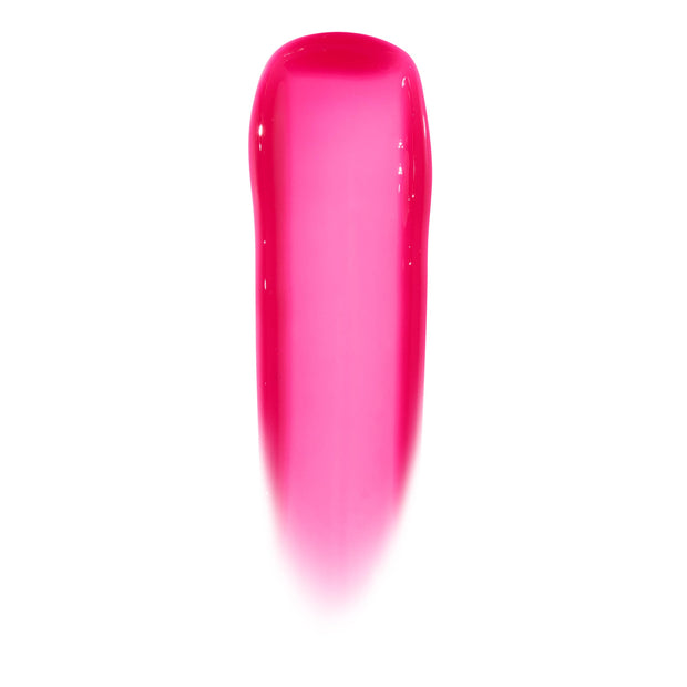 Glossy lip swatch shows the sheer hot pink, high-shine jelly finish of the ColourPop Ultra Glossy Lip in Surfer Vibes, displayed as a smooth vertical swipe on a white background.