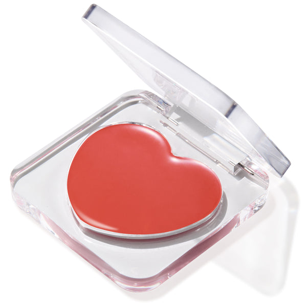 Second Date heart-shaped coral ColourPop Lip and Cheek Balm shown in a half-open clear acrylic compact, creamy glossy finish catching light on a clean white background.