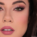Heart to Heart blush adds a soft peachy‑rose flush to the model’s cheek in a studio close‑up, paired with shimmery pink lids, bold lashes, and mauve lips - ColourPop Heart Powder Blush Set showcasing a natural matte finish.