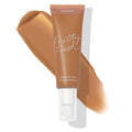 ColourPop Pretty Fresh Tinted Moisturizer tube in Medium Dark 14 W displaying a warm caramel swatch behind it, pump top attached; hyaluronic acid formula noted on the label against a clean white background.