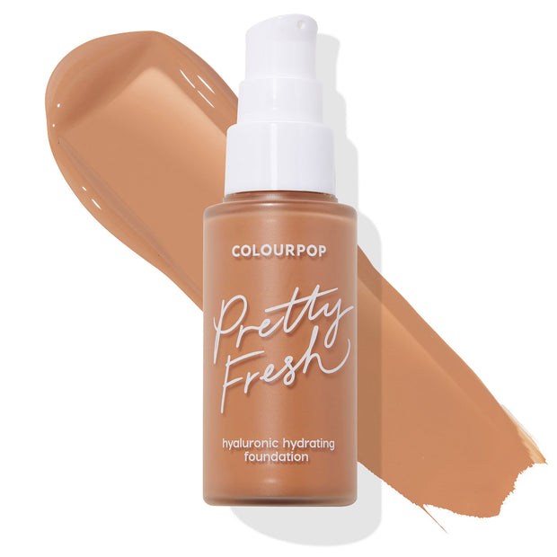 Frosted pump bottle of ColourPop Hyaluronic Hydrating Foundation Pretty Fresh in Medium Dark 148 N, standing with a medium-dark tan swatch swept behind on a white background, showcasing a neutral undertone.