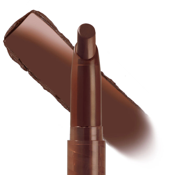 Pitch ColourPop Lippie Stix gliding a rich chocolate-brown swatch, the slim twist-up lip crayon uncapped on a white background, highlighting its creamy matte finish and warm undertone.